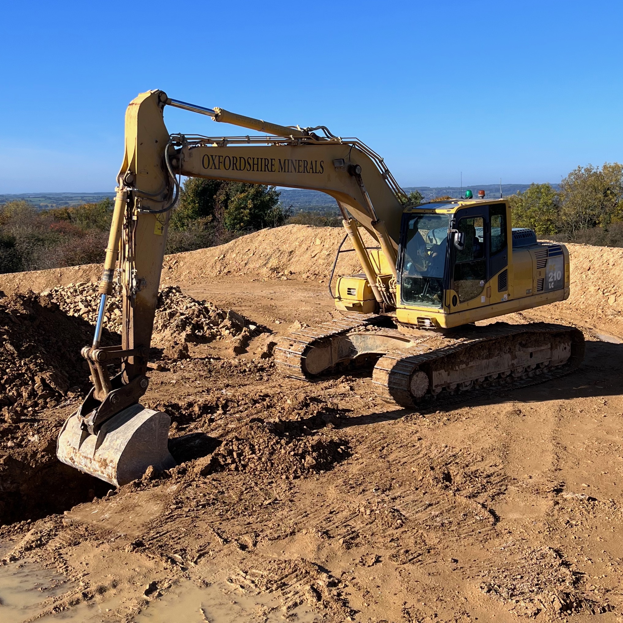 Trainee operating a 360 excavator during NPORS construction plant training, practicing safe digging and machine control on a worksite training ground